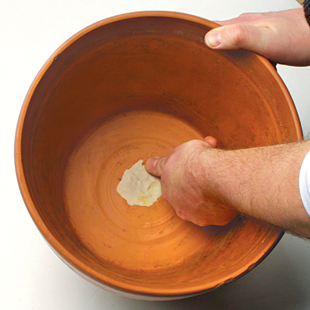plugging the hole in the bottom of a terra cotta pot with plumbers putty